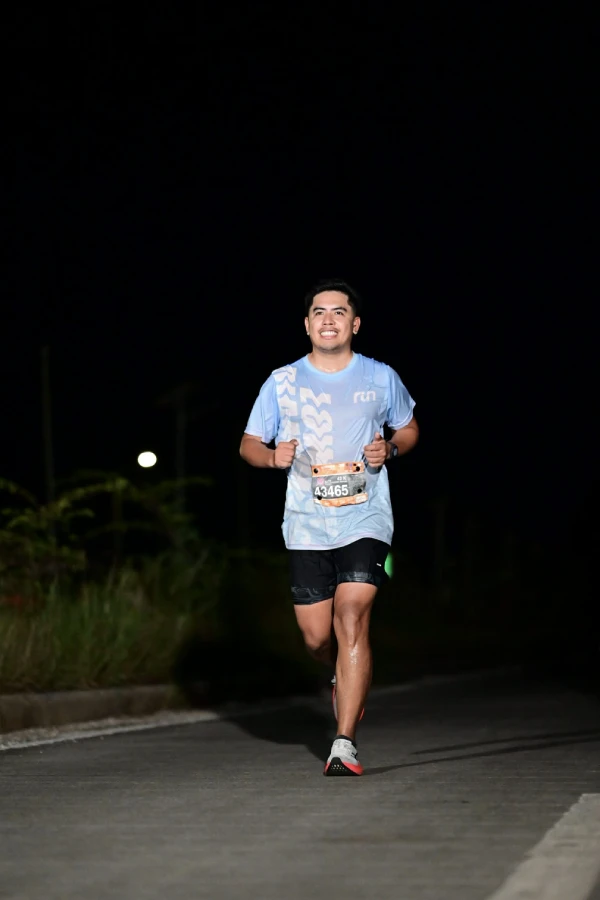 A man running in a race at night.